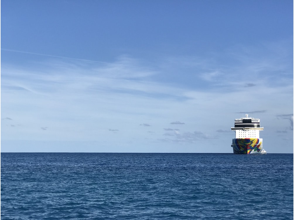 Cruise ship sitting in the ocean far away